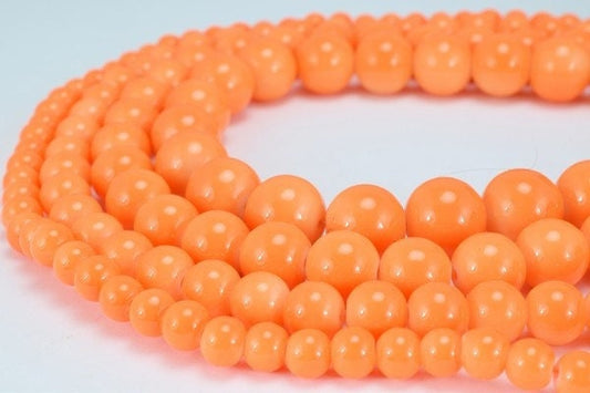 Orange beaded necklace strands arranged in a circular pattern