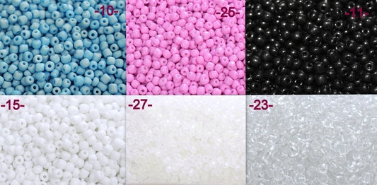 Multi-colored glass seed beads assortment in blue, pink, black, white, and clear.