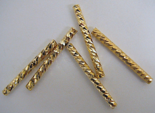 Golden spiral pattern metal beads for jewelry making.