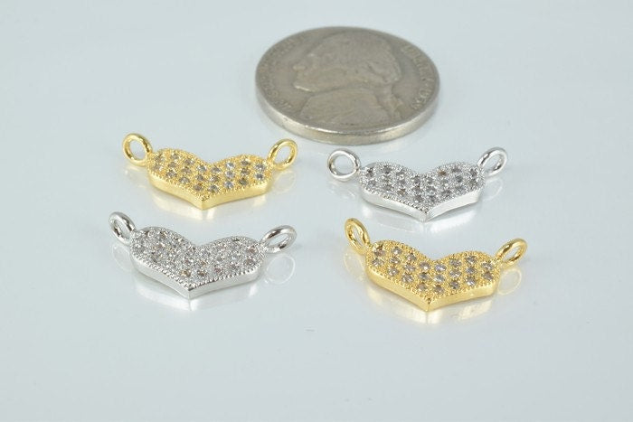 Gold and silver heart-shaped diamond connectors with coin for size comparison.