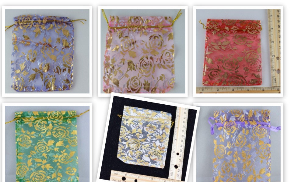 Colorful sheer organza gift bags with gold floral pattern and drawstring closure.